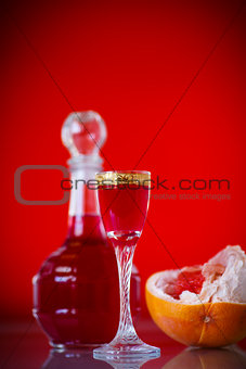sweet grapefruit alcoholic cordial in the decanter with a glass