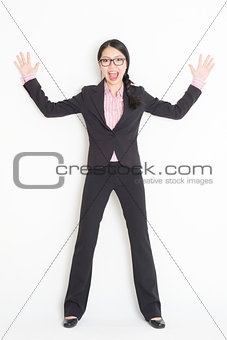 Shocked Asian businesswoman leaning wall