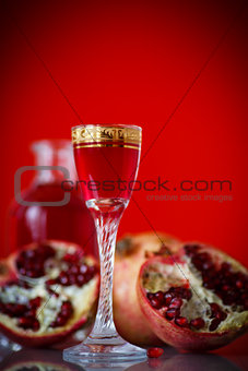 sweet pomegranate alcoholic cordial in the decanter with a glass