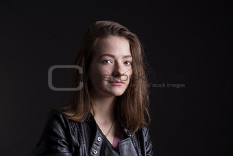 Young woman in leather jacket rock style over black background