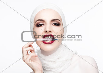 Beautiful model holding syringe in lips surgery