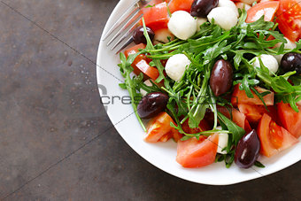 mozzarella salad with tomatoes and green arugula