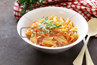 penne pasta with tomato sauce in a white plate