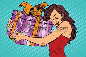 Beautiful young woman hugging gift box
