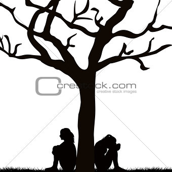 Sad women sitting under a tree