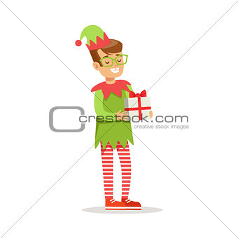 Boy in Glasses With Present Dressed As Santa Claus Christmas Elf For The Costume Holiday Carnival Party