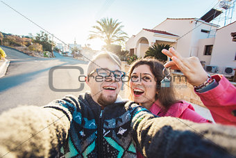 Happy smiling young couple showing a keys of their new house