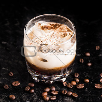 White russian with coffee beans on a table