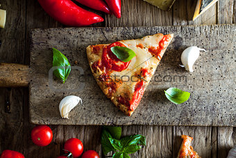Pizza on wood with ingredients