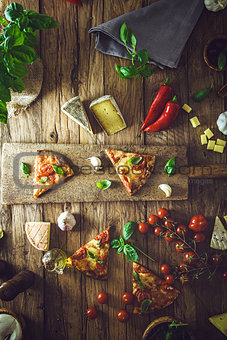 Pizza on wood with ingredients