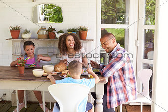 Family At Home Eating Outdoor Meal Together