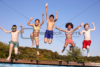 Group Of Children Jumping Into Outdoor Swimming Pool