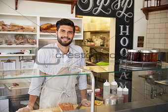 Small business owner behind the counter of a sandwich bar