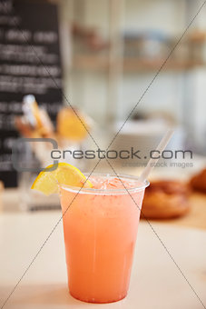 Glass of lemonade on the counter at a coffee shop, vertical