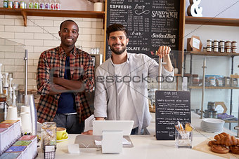 Business partners at the counter of a coffee shop, close up