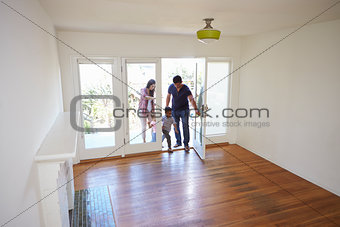 High Angle View Of  Family Exploring New Home On Moving Day