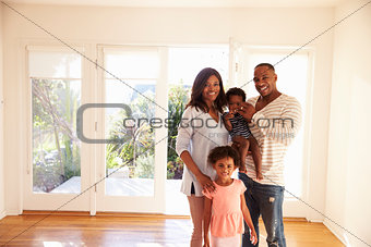 Portrait Of Family In New Home On Moving Day
