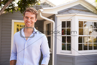 Portrait Of Man Standing Outside New Home