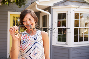 Woman With Keys Standing Outside New Home
