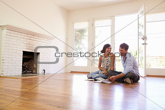 Excited Couple Planning Decoration Of New Home