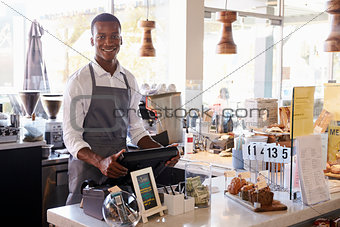 Portrait Of Male Employee Working At Delicatessen Checkout