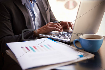 Close Up Of  Businessman Working On Laptop By Office Window