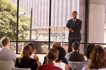 Black businessman presenting seminar smiling to audience