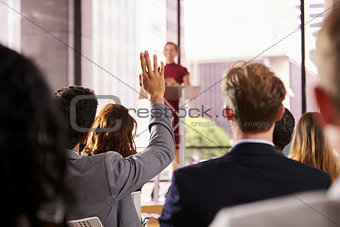 Presenter at business seminar takes a question from audience