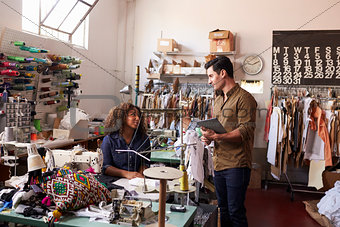 Colleagues talking at a clothes manufacturing workshop