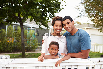 Young African American family outside their new house