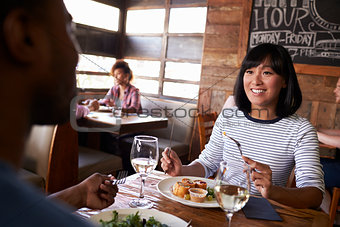 Over shoulder view of couple having lunch in a restaurant