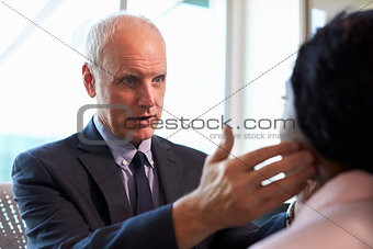 Doctor In Examining Female Patient In Office