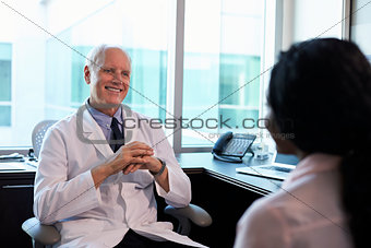 Doctor In Consultation With Female Patient