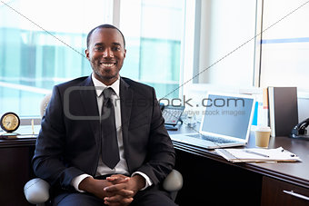 Portrait Of Doctor Sitting At Desk In Office