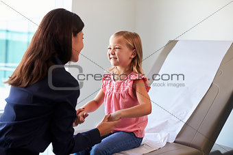 Pediatrician With Child In Exam Room