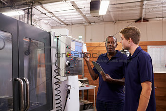 Engineer Training Male Apprentice On CNC Machine