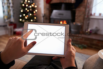 Man Using Digital Tablet In Room Decorated For Christmas