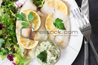 steamed tilapia fish with salad and tartar sauce with appliances