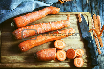 fresh long carrot on a chopping board