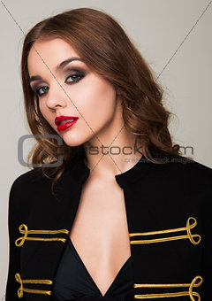 Beautiful fashion model wearing black gold jacket