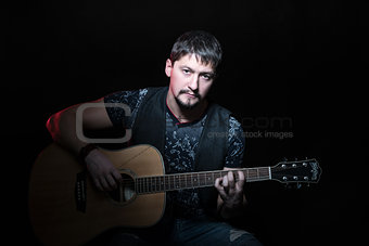 Portrait of a man with acoustic guitar