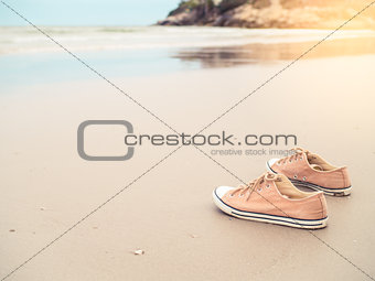 Canvas shoes on the sand beach