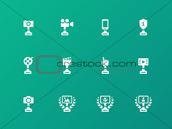 Award icons on green background.
