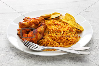 jollof rice with chicken and fried plantain, west african cuisine