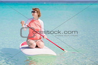 woman stand up paddleboarding