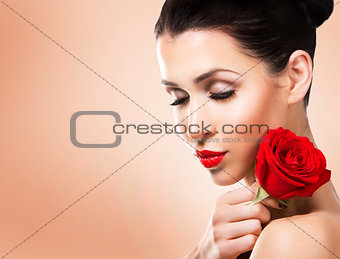 romantic woman holding red rose on beige background