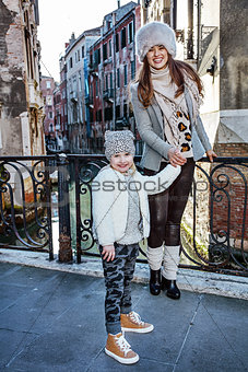 mother and daughter tourists in Venice having walking tour