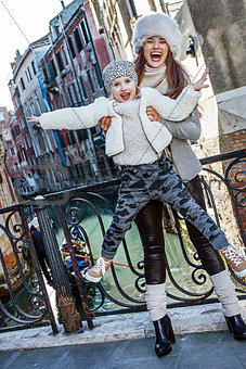 smiling mother and daughter tourists in Venice having fun time