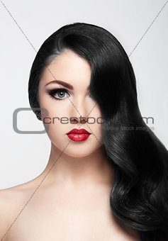 Beauty brunette model with long hair and red lips