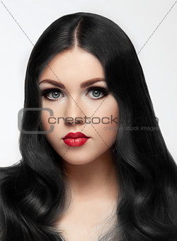 Beauty brunette model with long hair and red lips